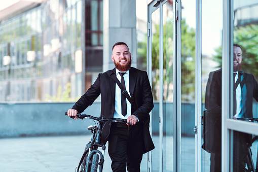 Environmental Conservation Shown By Male Businessman Going To Work By Bicycle