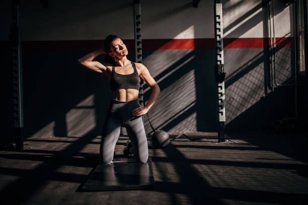 istock Fit young woman kneeling in gym 1227106353