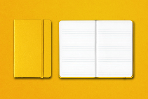 Yellow closed and open lined notebooks isolated on colorful background