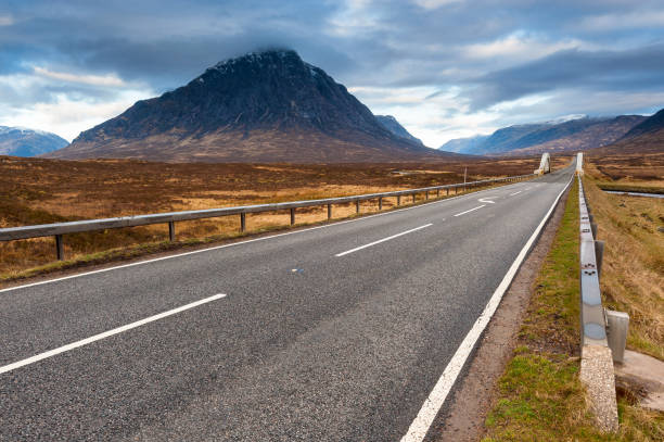 Buachaille Etive Mor and A82 road in early morning light, Glencoe, Scotland Buachaille Etive Mor, the distinctive pyramidal mountain that sits at the head of Glencoe in the Scottish Highlands, Scotland. glen etive photos stock pictures, royalty-free photos & images