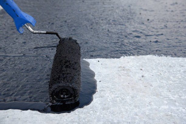 istock Worker applies bitumen mastic on the foundation 1227106860