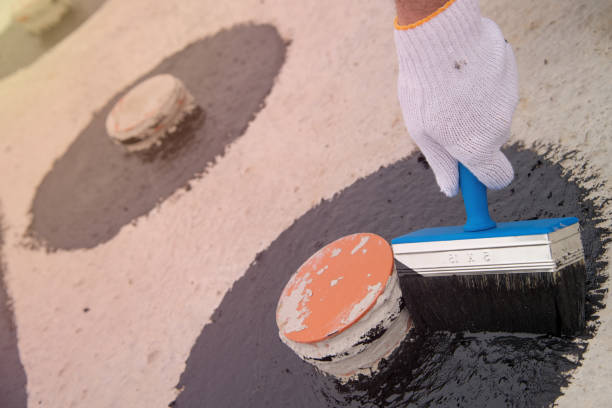 istock Worker applies bitumen mastic on the foundation 1227106861