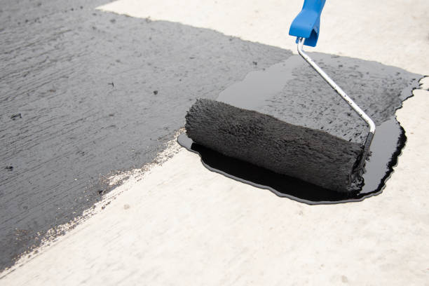 istock Worker applies bitumen mastic on the foundation 1227107063