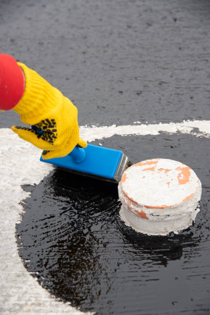 istock Worker applies bitumen mastic on the foundation 1227107075