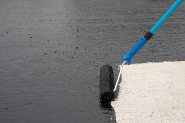 istock Worker applies bitumen mastic on the foundation 1227107119