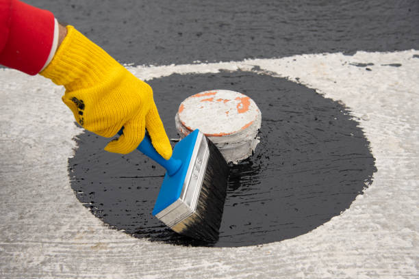 istock Worker applies bitumen mastic on the foundation 1227107121