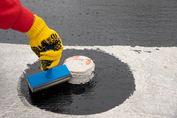 istock Worker applies bitumen mastic on the foundation 1227107163