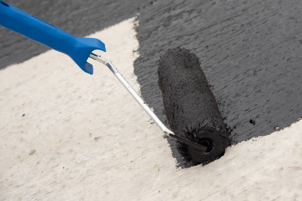 istock Worker applies bitumen mastic on the foundation 1227107166