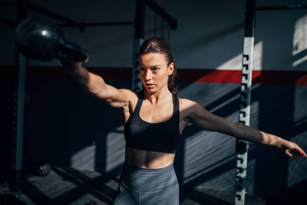 istock Fit young woman training with kettlebell in gym 1227107245