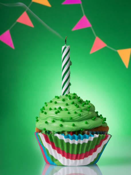 istock Delicious birthday cupcake on table, colorful background. 1227108207