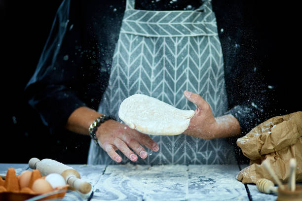 istock The man, chef cooks throws the dough, flying, freezing in motion. 1227109332
