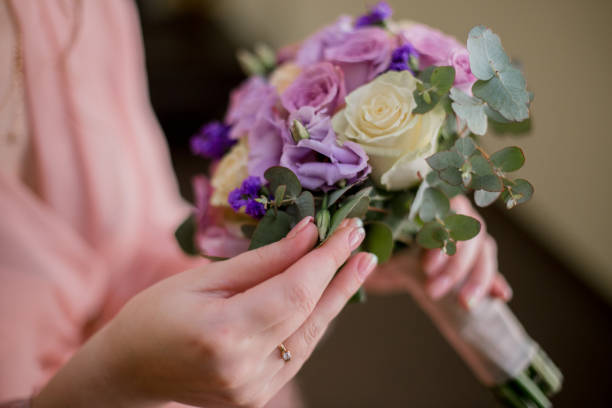 istock woman in bathrobe with a wedding bouquet 1227111881