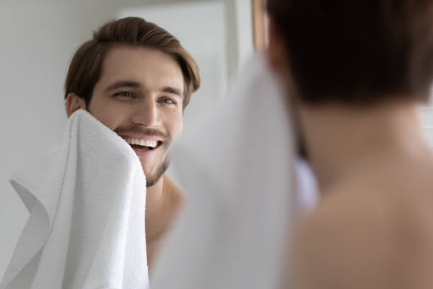 istock Smiling young man washing in morning in bathroom 1227112402