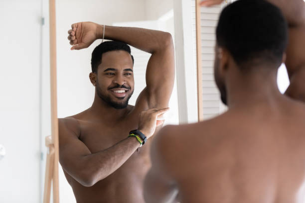 istock Naked african american man use deodorant in bathroom 1227113484