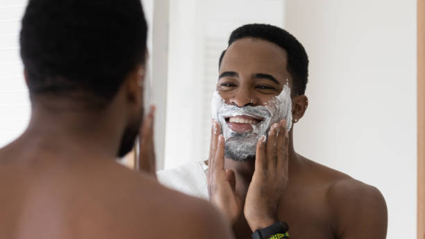 istock African American man use foam shaving beard in bathroom 1227113487