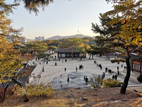 Tourists sightseeing at the Changdeokgung Palace, set within a large park in Jongno-gu, Seoul, South Korea. It is one of the \