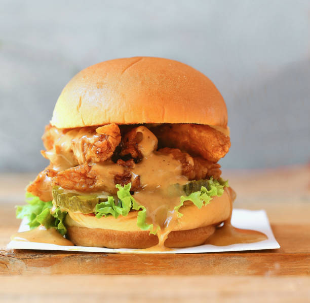 istock Crispy Chicken Burger on a table, Gourmet Creations, side view. Close up of crispy chicken burger. 1227116779