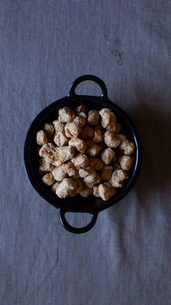 istock soya chunks lying inside black colour bowl. grey coloured background. most eatable food ingredient soya chunk