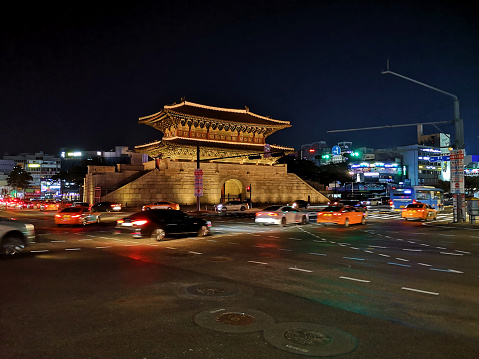 Road traffic at Dongdaemun gate by night, Seoul, South Korea.
