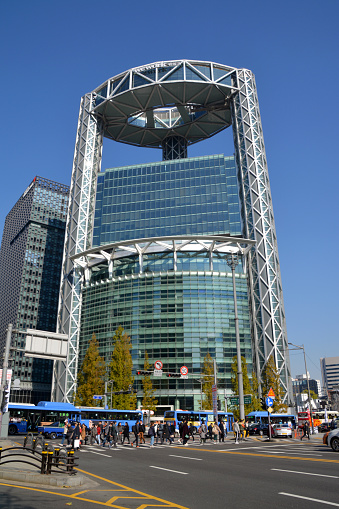People walking on the street by the Jongno Tower, a 33-story office building in Jongno, Seoul. Its top floor is equipped with a restaurant and bar which is famous for its view of Jongno and other areas of Seoul. Its height is 132 meters.