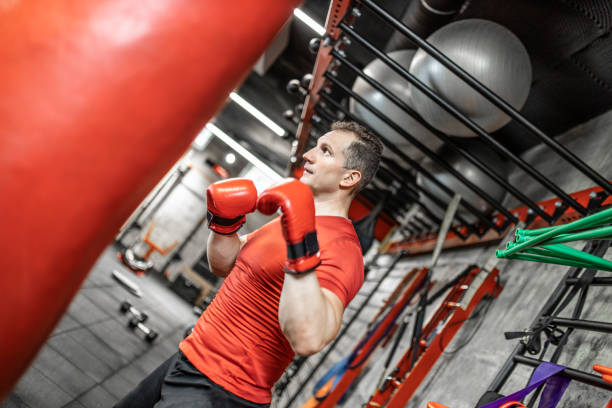 istock Fighter training in the gym with the punch bag 1227120469