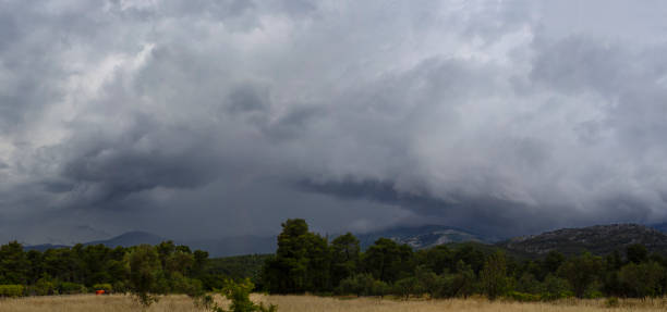 istock Panoramic view of the village, mountains and sky with black storm clouds before the spring storm on the island of Evia in Greece 1227121904