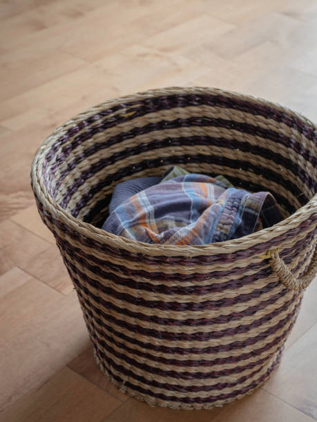 istock Brown Straw Laundry Basket on the Wooden Floor 1227122005
