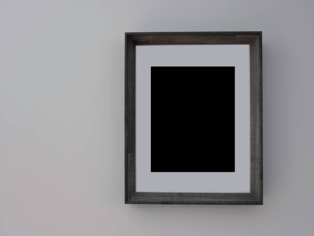 istock Black blank picture frame with drift wood frame on gray wall 1227122014
