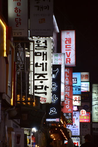 Neon placards on a bar street by night in Gagnam, a popular entertainment and nightlife district in Seoul, South Korea.