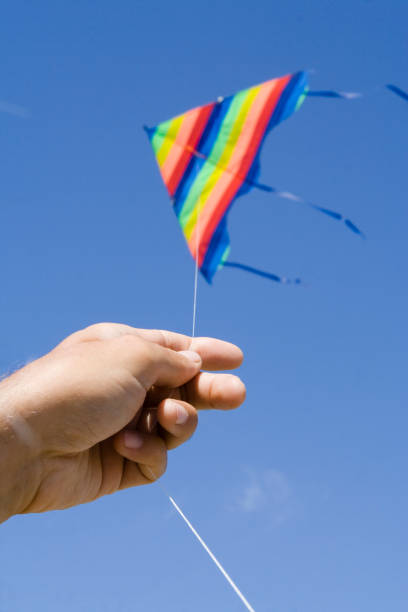 istock Hand holding a kite against blue sky 1227126812