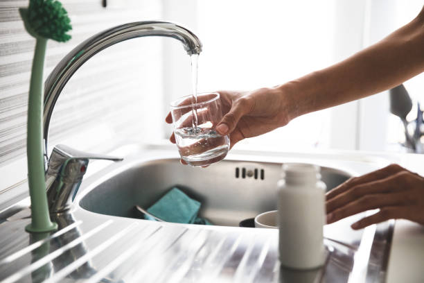 istock Young woman taking supplements at home 1227128406