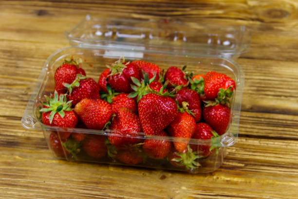 istock Fresh strawberry in plastic box on a wooden table 1227128408