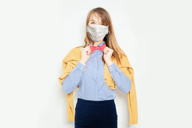 istock Happy model woman in protective mask smiling and posing on white background 1227130980
