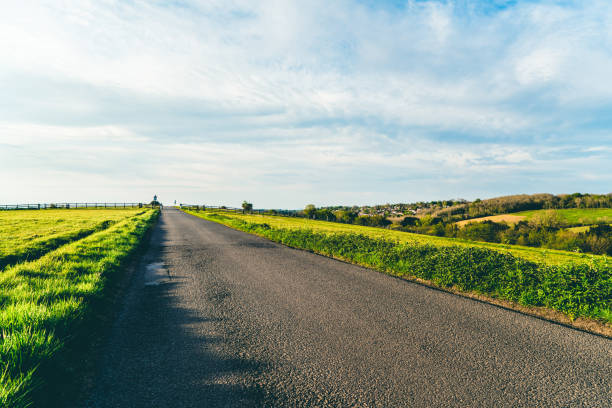 istock road in green field and mountains 1227130996