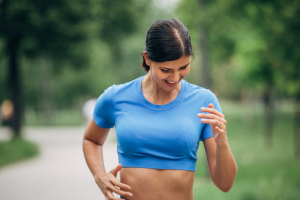 istock Fit young woman jogging alone in park 1227131446