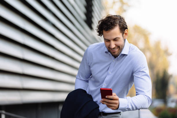 istock Portrait of a businessman using mobile phone and text messaging 1227132569