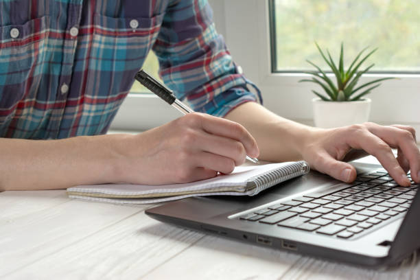istock Modern work place for distance learning at home with black laptop 1227133202