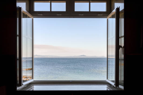 istock view from a dark room to the sea through an open window 1227133840
