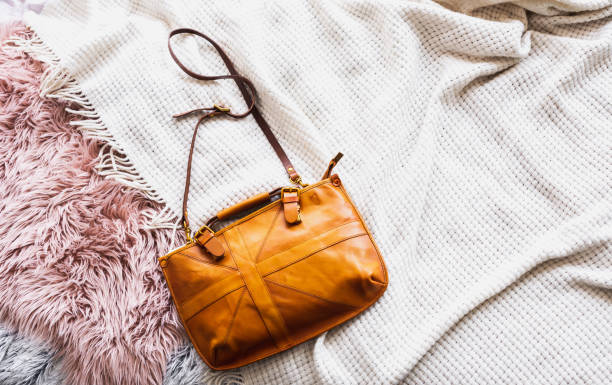 istock Leather yellow bag on textile background 1227136757