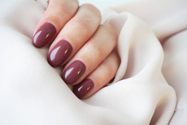 istock Violet manicure and pink silk. 1227138354
