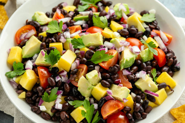 istock Avocado, mango salad with black bean, tomato, red onion and tortilla chips. healthy food 1227139727