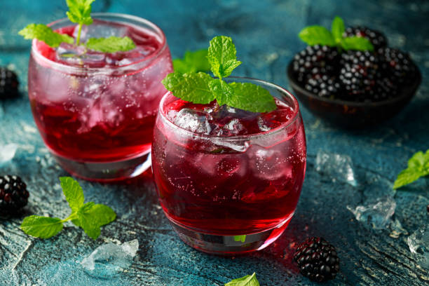 istock Refreshing Blackberry cocktail with ice and mint on rustic background 1227139837