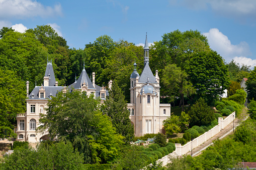 Pierrefonds, France - May 25 2020: The castle of Jonval built at the beginning of the 20th century on the ruins of an old medieval castle has a fairly original composite architecture. The building has been classified as a Historic Monument since 1944.