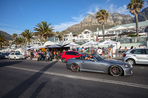Cape Town, South Africa, November 12, 2017 : Camps Bay in Cape Town, South Africa. This is a popular beach with tourists as well as the locals.