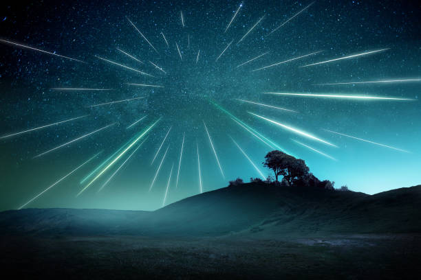 Perseids Shooting Stars Meteor Shower Night Landscape A large meteor shower on a misty evening with streaks across the sky. Shooting stars landscape astrophotography composite. meteor shower stock pictures, royalty-free photos & images