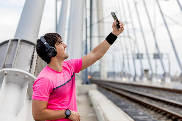 istock Happy sportive man taking selfie portrait with smartphone after training 1227146294