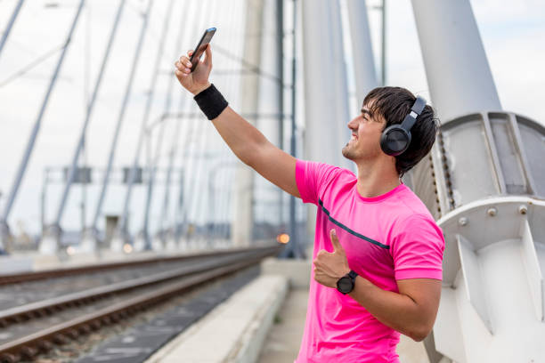 istock Happy sportive man taking selfie portrait with smartphone after training 1227146308