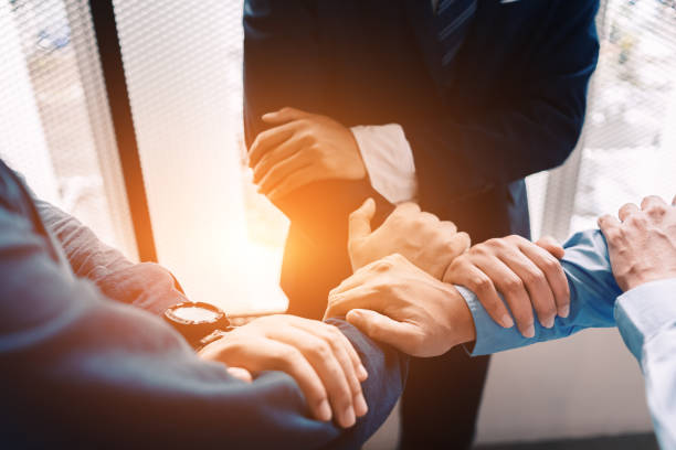 istock Business team work join hands together. group people hands were collaboration to trust in business. 1227146489