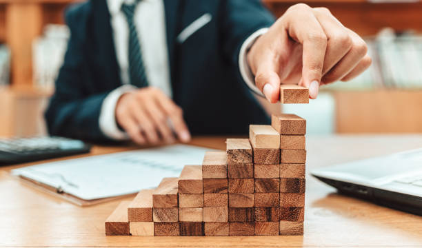 istock Ant eye view Male hand stacking wooden blocks. Business development and growth concept 1227146670