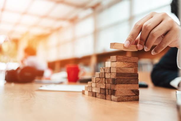 istock Ant eye view Male hand stacking wooden blocks. Business development and growth concept 1227147515